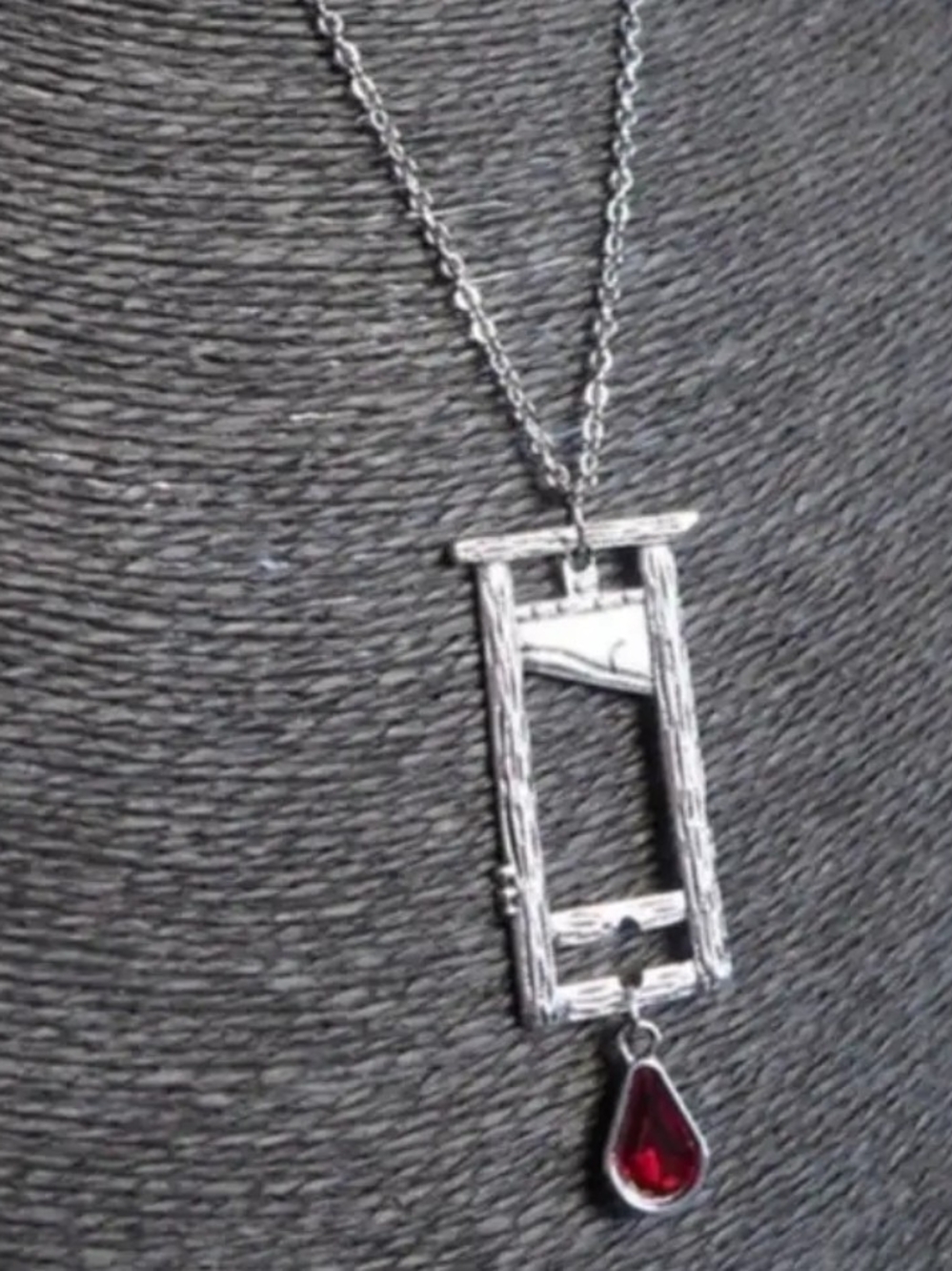 Silver-Tone Guillotine Pendant Necklace with Red Teardrop Gem